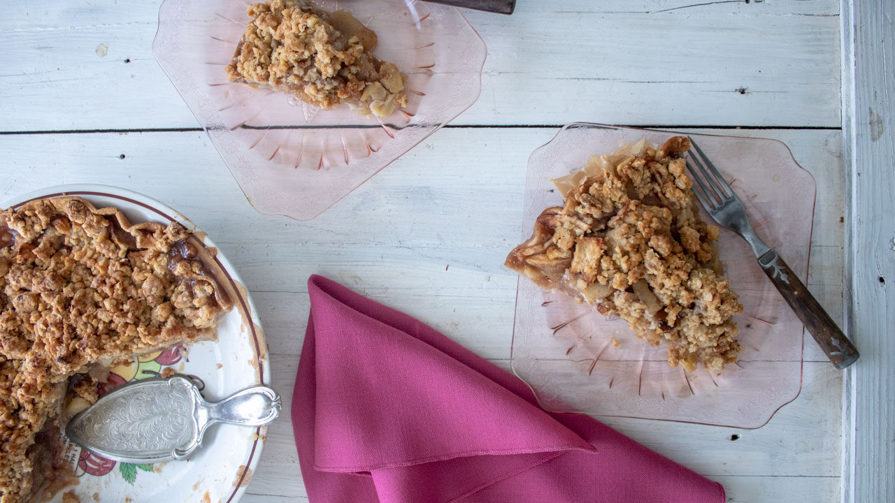 Slices of apple pie and antique depression glass plates.