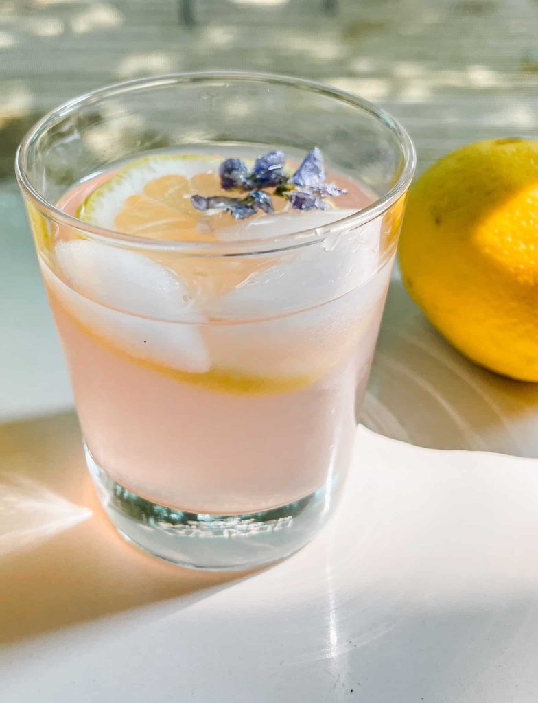 A glass of Wild Violet Lemonade and Syrup